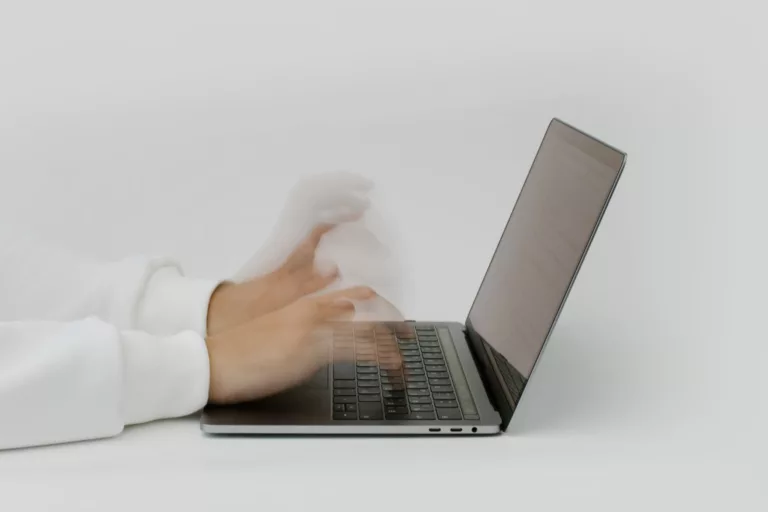 Hands Typing on a Laptop Keyboard